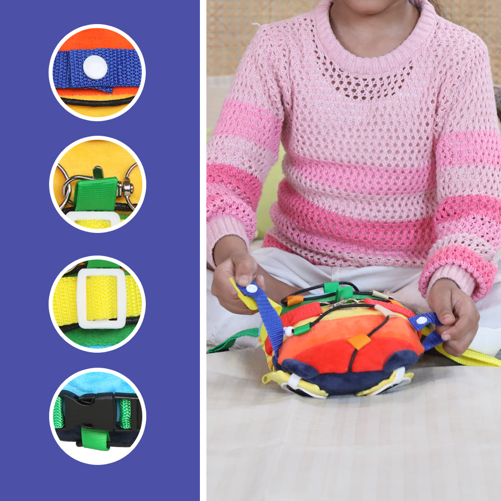 Child playing with colorful sensory buckle activity toy for fine motor skills with straps and buckles