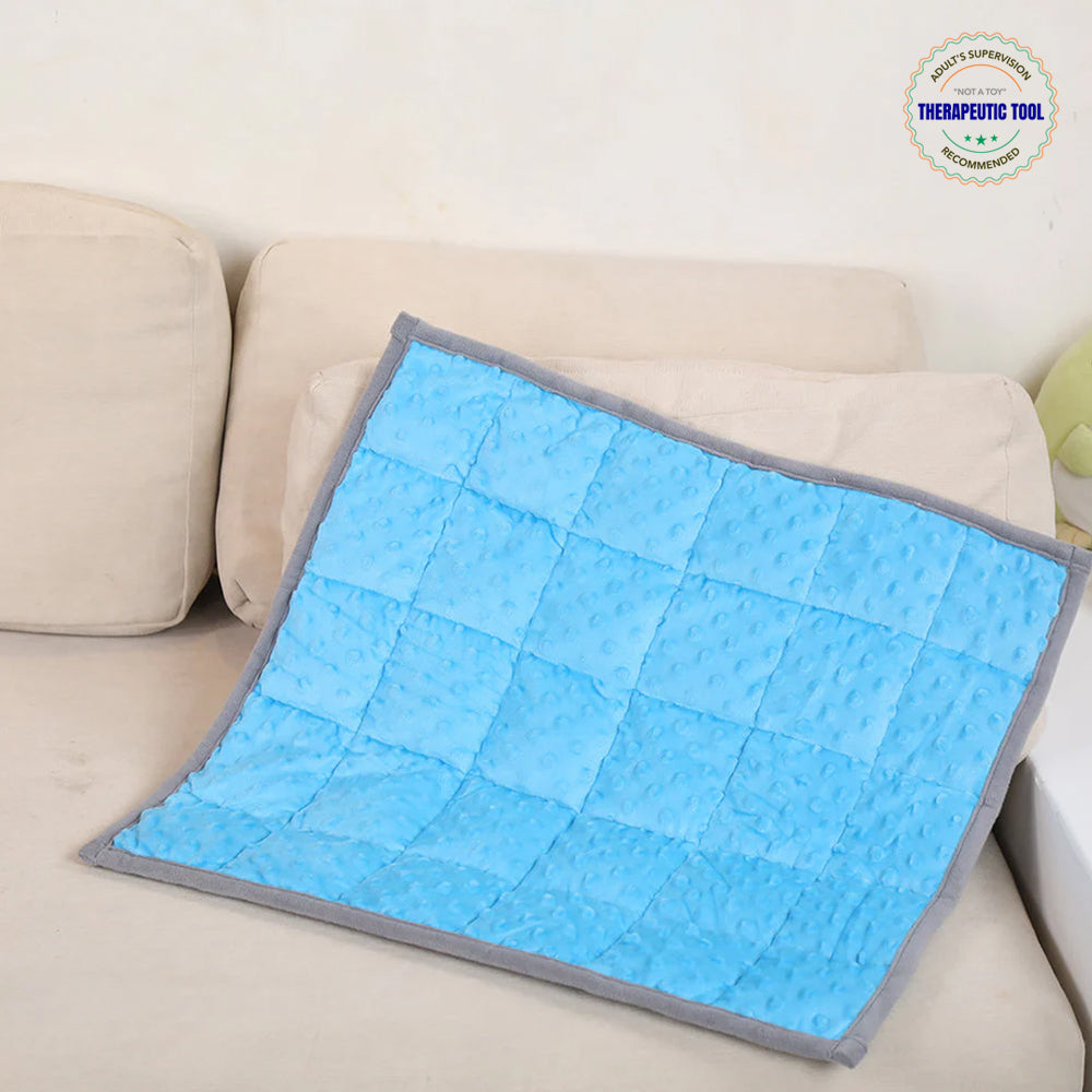 Ableys blue quilted sensory mat on sofa textured cover and gray trim therapeutic tool weighted lap pad for focus