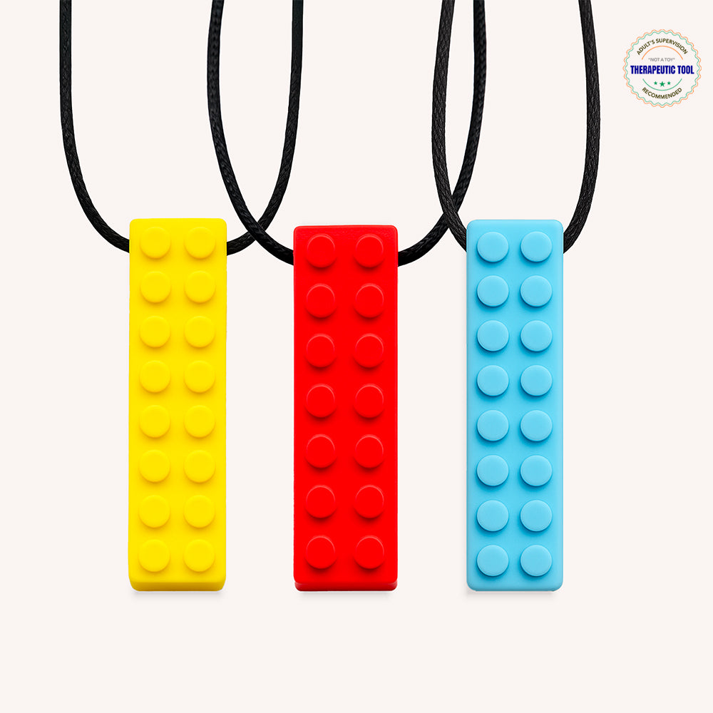 Ableys chewable necklaces for sensory needs three silicone brick pendant chews in yellow red and blue on black cords
