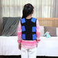 Ableys compression vest for sensory needs on child with blue back pads worn over pink sweater in bedroom