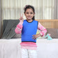 Ableys blue compression vest for sensory needs worn by smiling child over pink sweater in bedroom