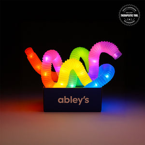 Colorful glowing LED pop tubes sensory toys in Ableys box showing multicolor flexible light up sensory fidget tubes