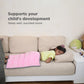 Ableys pink weighted lap pad for focus on a child sleeping on a beige couch with pillow