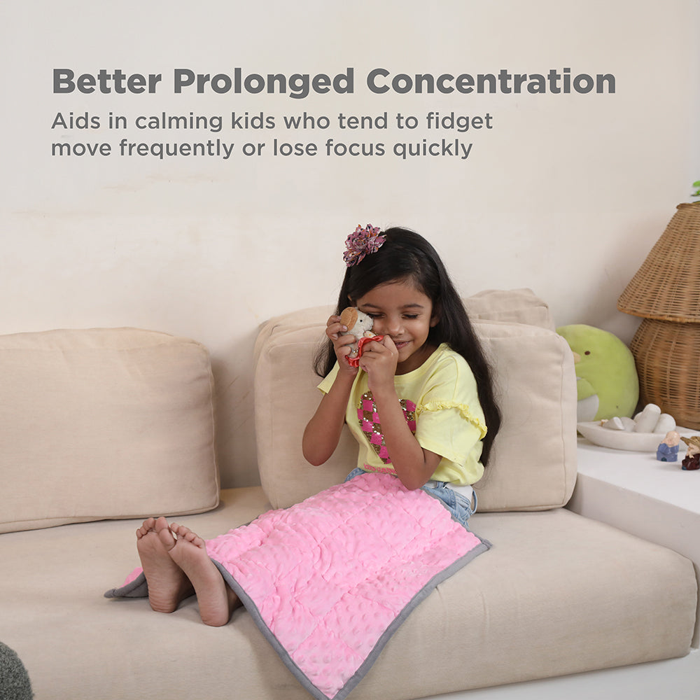 Ableys weighted lap pad for focus pink calming lap pad on girl sitting on couch promoting concentration