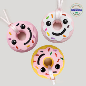 Three donut silicone chewable necklaces for sensory needs smiling pink white yellow sprinkle pendants on cords