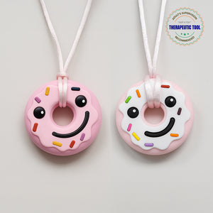 Ableys pastel donut chewable necklaces for sensory needs pink and white smiling donut pendant on adjustable white cords