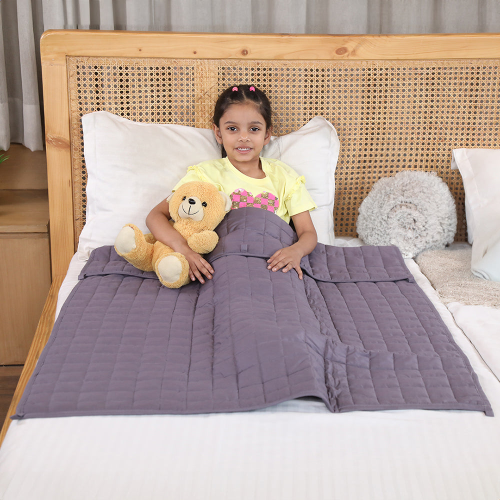 Ableys weighted blanket for kids gray quilted lap blanket on smiling girl holding teddy on bed