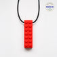 Ableys red silicone building block pendant on black cord chewable necklace for sensory needs durable textured teether