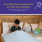 Ableys compression bed sheet for sensory needs on child reading in bed with light blue fitted sheet and plush toys