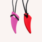 Ableys chewable necklace for sensory needs two silicone fang pendants in pink and red on black cord