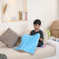 Ableys light blue quilted weighted lap pad for focus on a child seated on a beige sofa